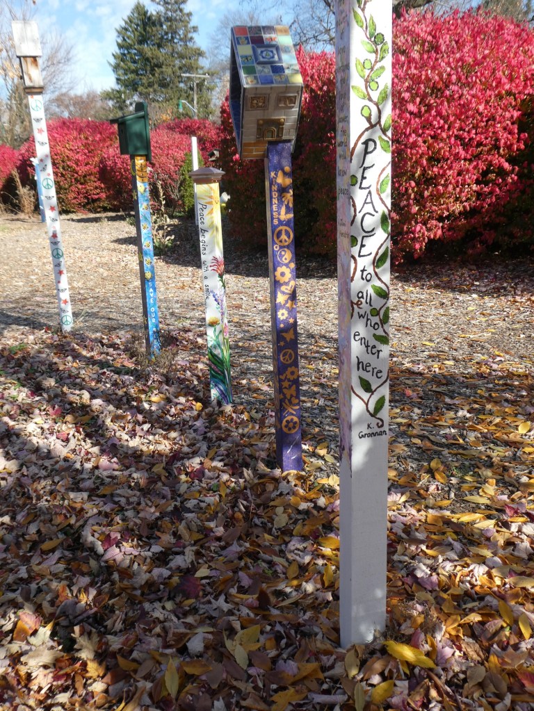 pillars painted with images of nature and expressions for peace in local park